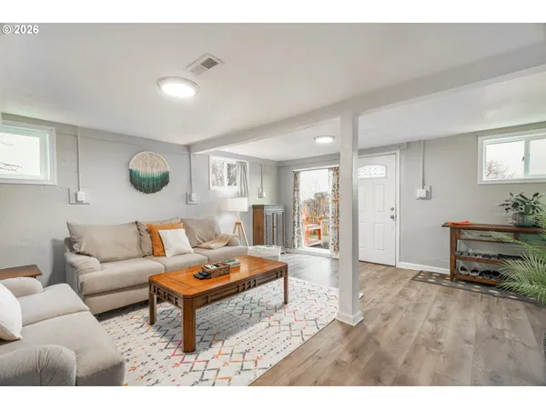 a living room with furniture and wooden floor