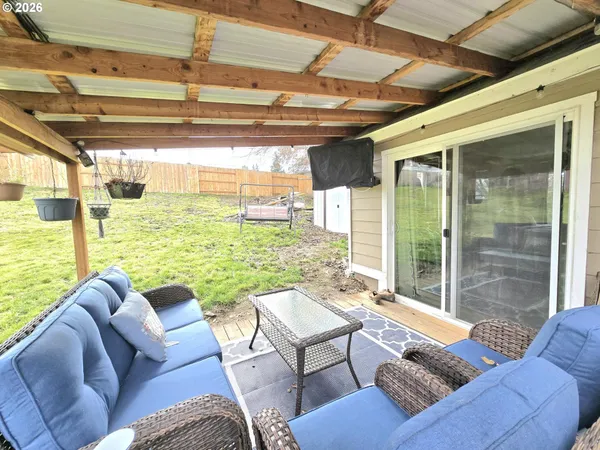 a living room with furniture and a floor to ceiling window