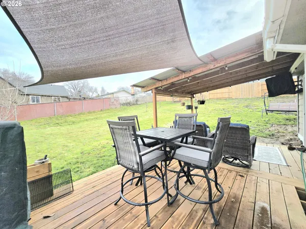 a view of a patio with lawn chairs next to a yard