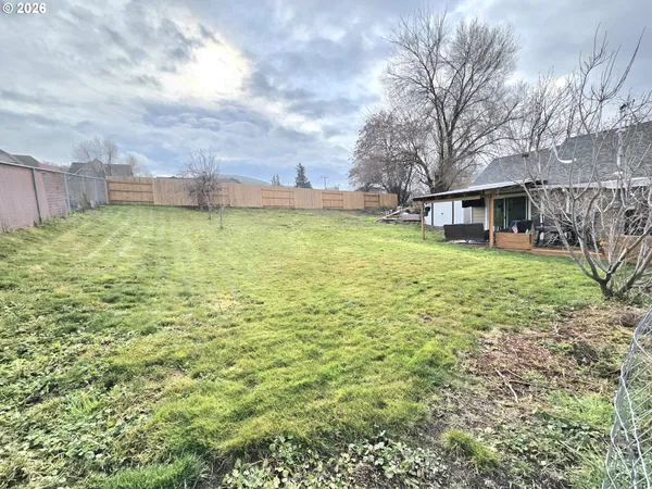 a view of a house with a yard and sitting area