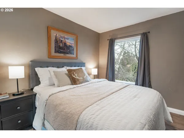 a bedroom with a bed and a lamp