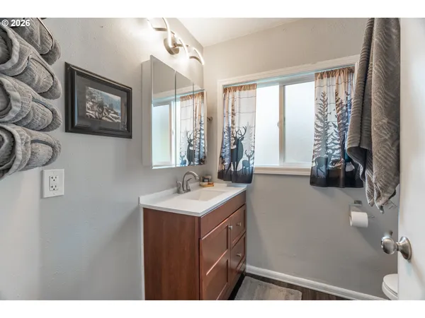 a bathroom with a sink a mirror and a window