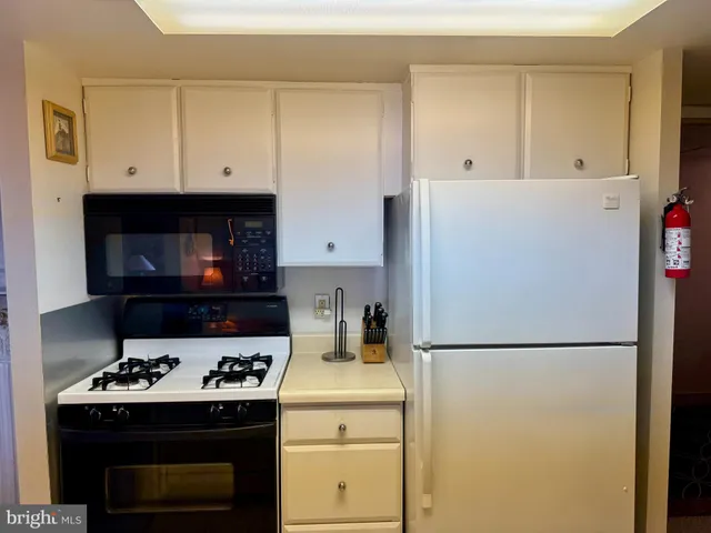 a kitchen with a stove and a refrigerator
