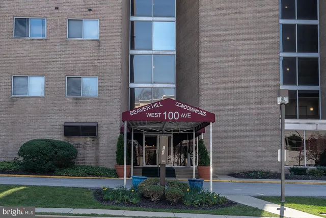 a front view of a brick house with a small yard