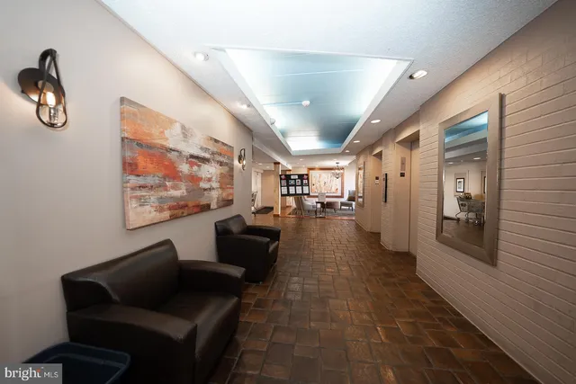 a lobby with furniture and a rug