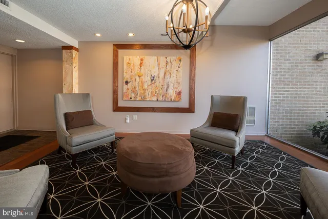 a living room with furniture a rug and a window