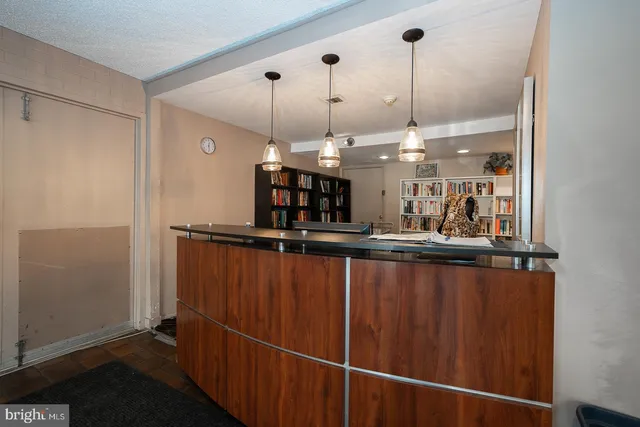 a kitchen with stainless steel appliances granite countertop a refrigerator a sink and a wooden floors