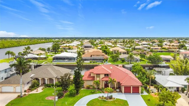 an aerial view of residential houses with outdoor space and swimming pool