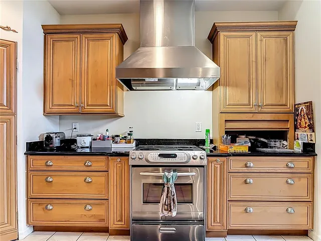 a spacious bathroom with a granite countertop shower a sink and a mirror
