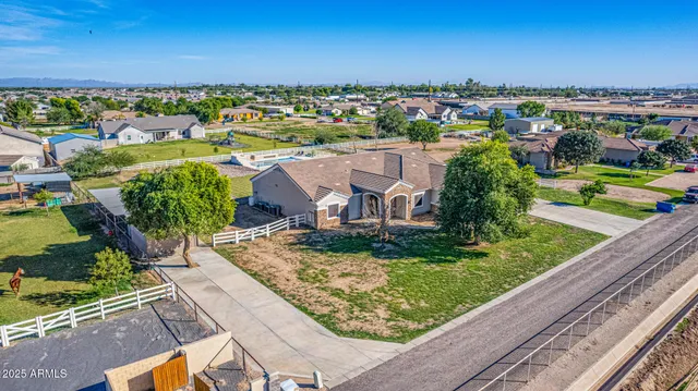 a living room with stainless steel appliances furniture a flat screen tv and a window