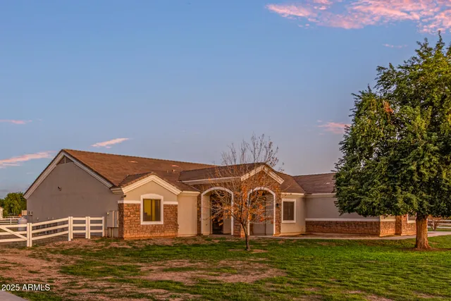 a living room with furniture a chandelier and a window