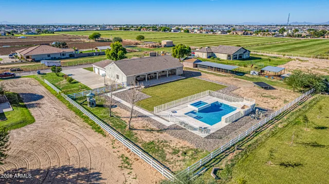 a view of swimming pool with outdoor seating and a garden