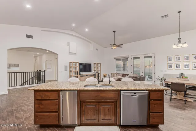 a kitchen with stainless steel appliances granite countertop a stove a sink dishwasher and a refrigerator