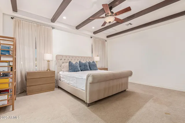 a living room with furniture and a ceiling fan