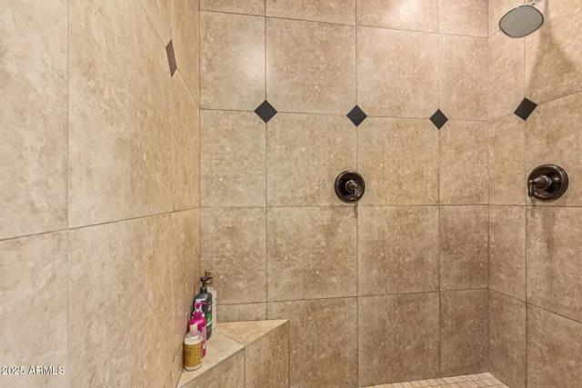 a view of a patio with table and chairs with plants and wooden fence