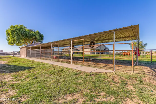 a view of a swimming pool with table and chairs