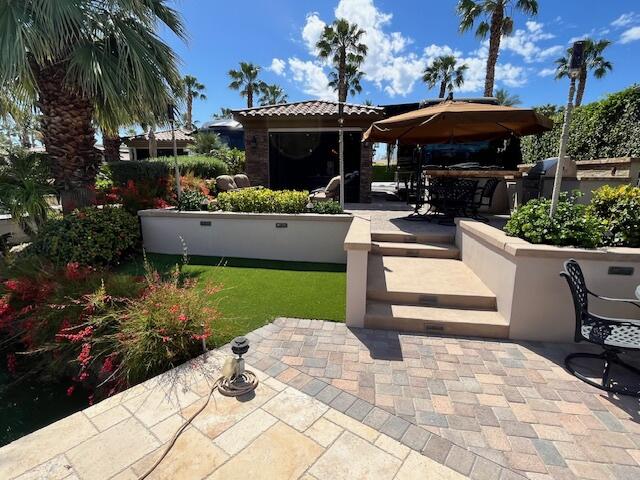 80501 Ave 48, Unit 214 Indio, CA 92201 - Photo 18 of 21 a front view of a house with garden