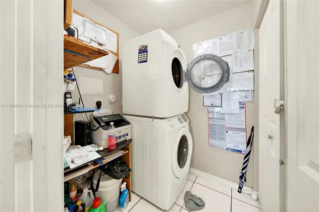 a storage room with washer and clock