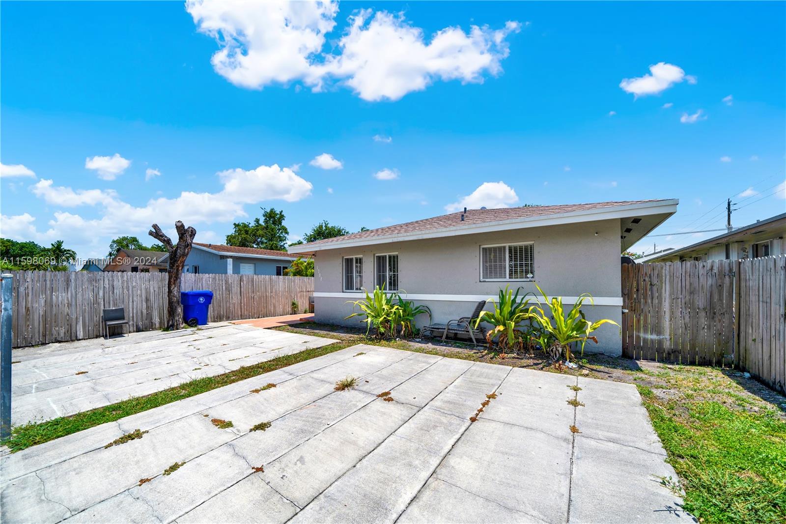 1786 Northwest 47th Terrace Miami, FL 33142 - Photo 14 of 25 a view of a house with a yard and potted plants