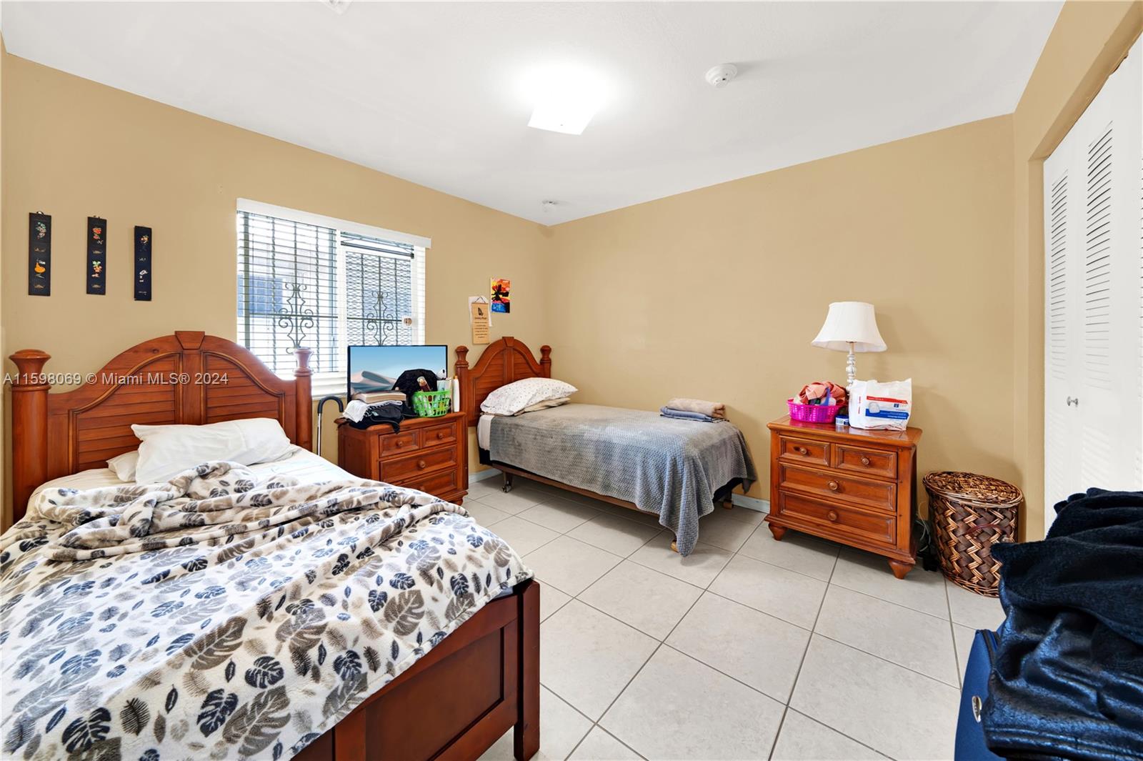 1786 Northwest 47th Terrace Miami, FL 33142 - Photo 15 of 25 a bedroom with a bed and a window