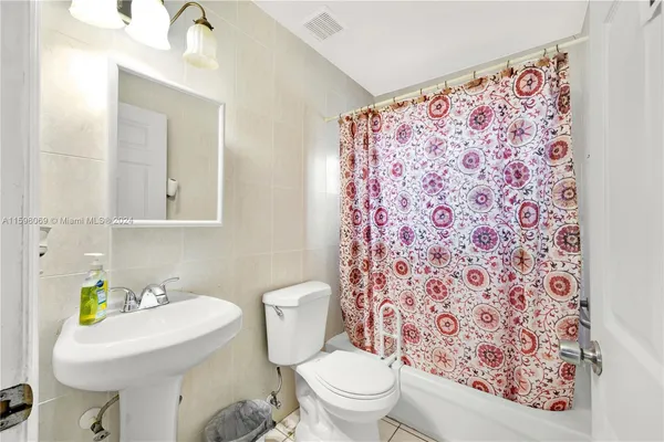 a bathroom with a sink toilet and mirror