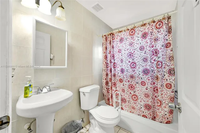 a bathroom with a sink toilet and mirror