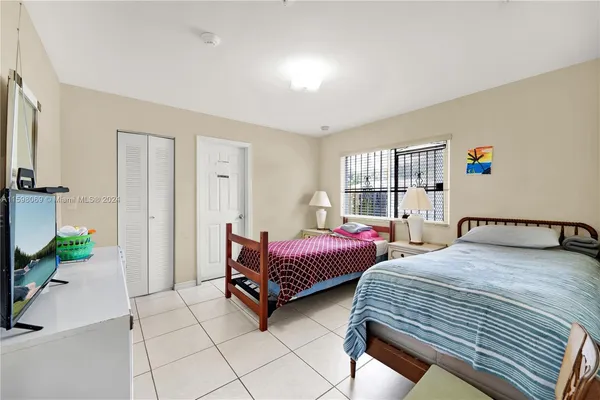 a bedroom with two beds and a large window