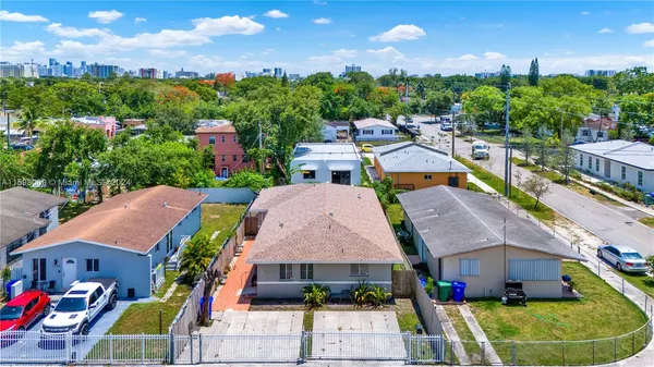 an aerial view of multiple houses with a yard