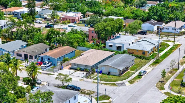 an aerial view of multiple houses with yard