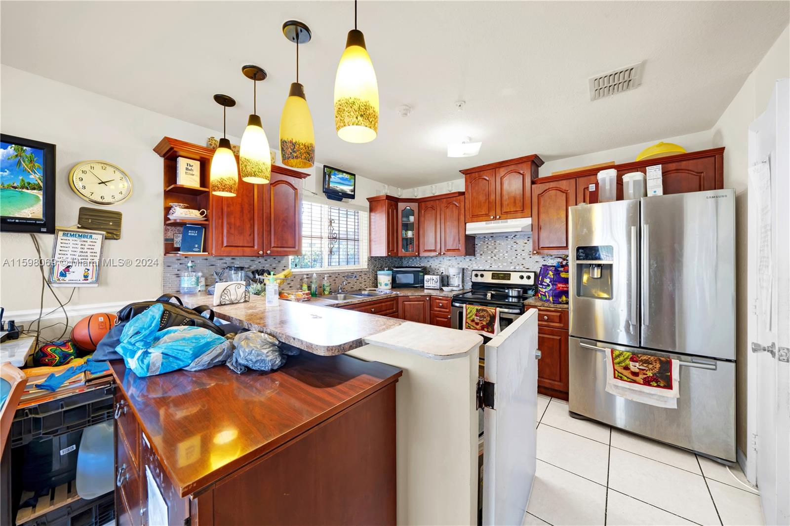 1786 Northwest 47th Terrace Miami, FL 33142 - Photo 6 of 25 a kitchen with stainless steel appliances granite countertop a refrigerator and a stove top oven
