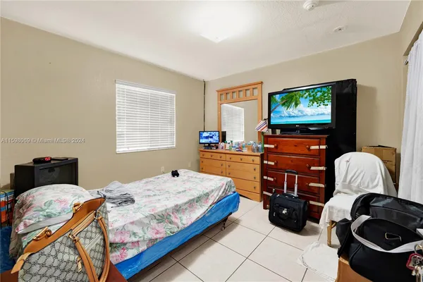 a bedroom with a bed and dresser