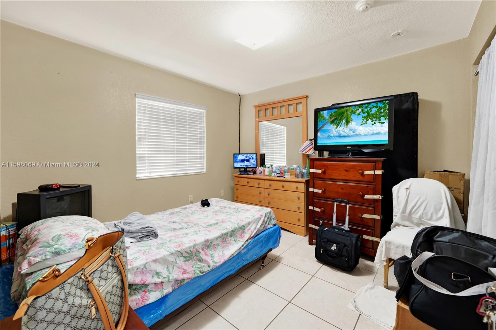 1786 Northwest 47th Terrace Miami, FL 33142 - Photo 8 of 25 a bedroom with a bed and dresser