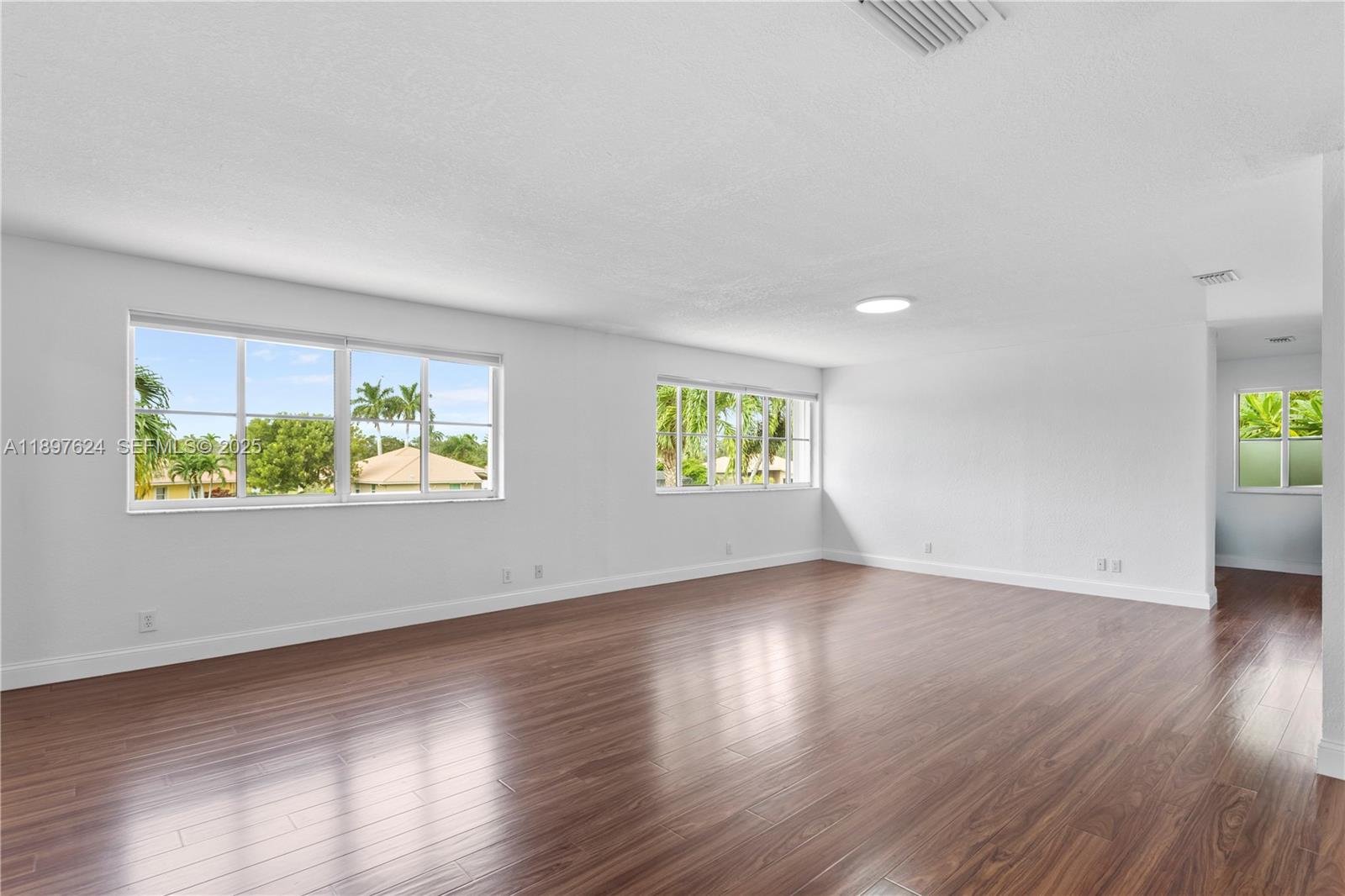 3620 Heron Ridge Lane Weston, FL 33331 - Photo 14 of 37 an empty room with wooden floor and windows