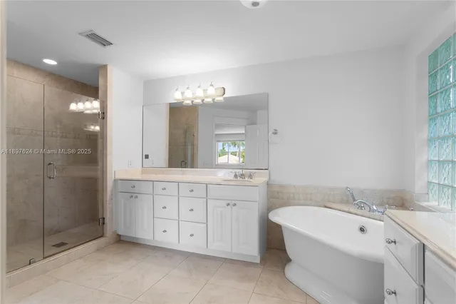 a spacious bathroom with a double vanity sink mirror and double