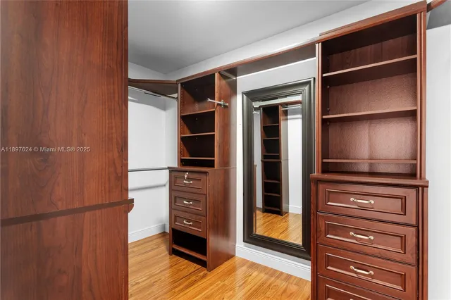 a view of walk in closet with empty racks