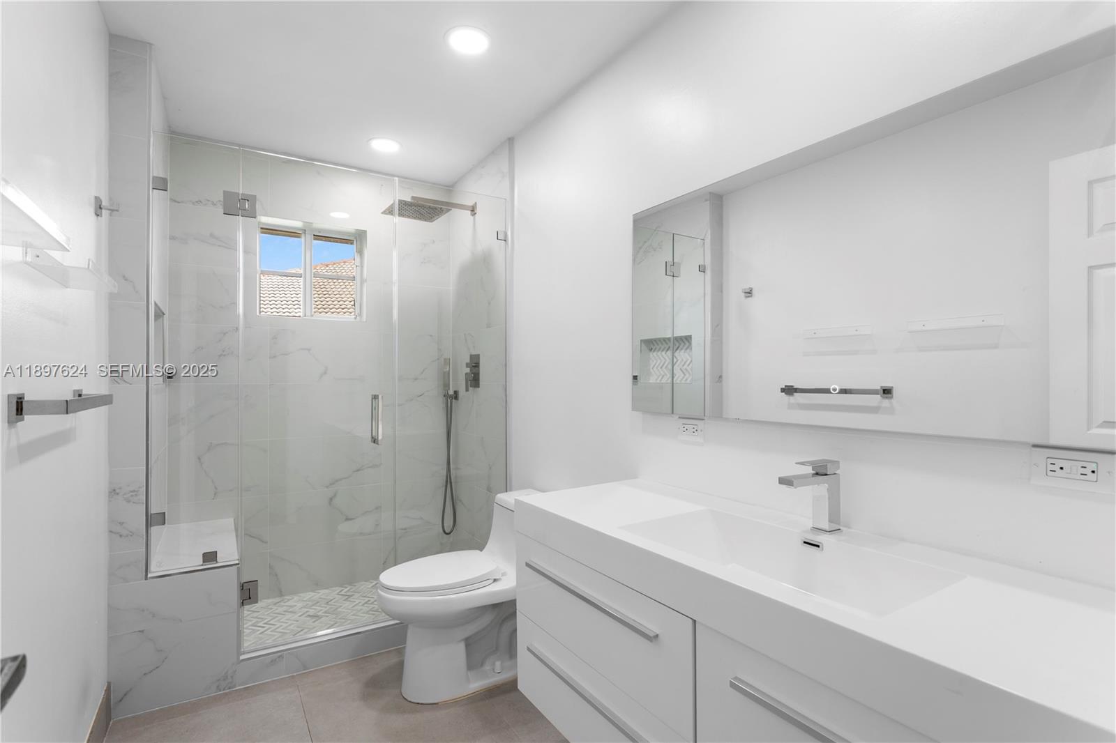 3620 Heron Ridge Lane Weston, FL 33331 - Photo 21 of 37 a bathroom with a shower sink vanity mirror and toilet
