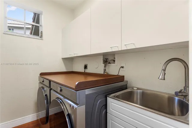 a kitchen with stainless steel appliances a sink and cabinets