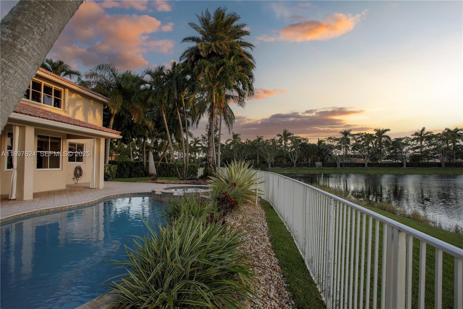 3620 Heron Ridge Lane Weston, FL 33331 - Photo 25 of 37 a view of a lake with a mountain in the background