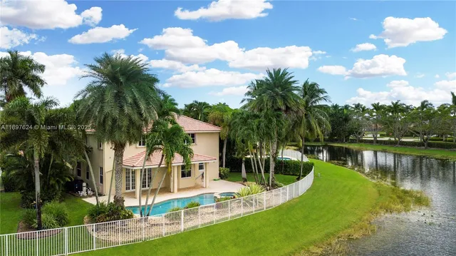 a view of a house with a yard and potted plants
