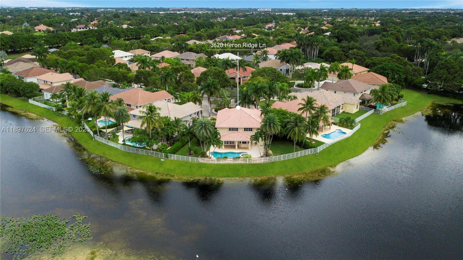3620 Heron Ridge Lane Weston, FL 33331 - Photo 29 of 37 an aerial view of a house with a garden and lake view