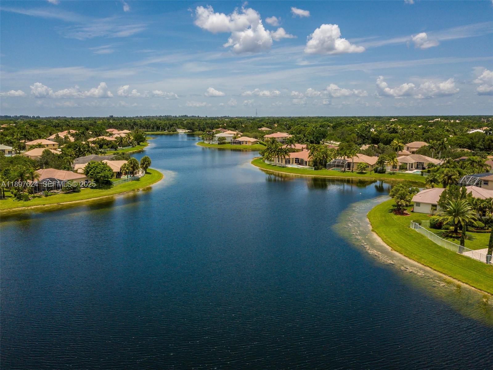 3620 Heron Ridge Lane Weston, FL 33331 - Photo 37 of 37 a view of a lake with a houses