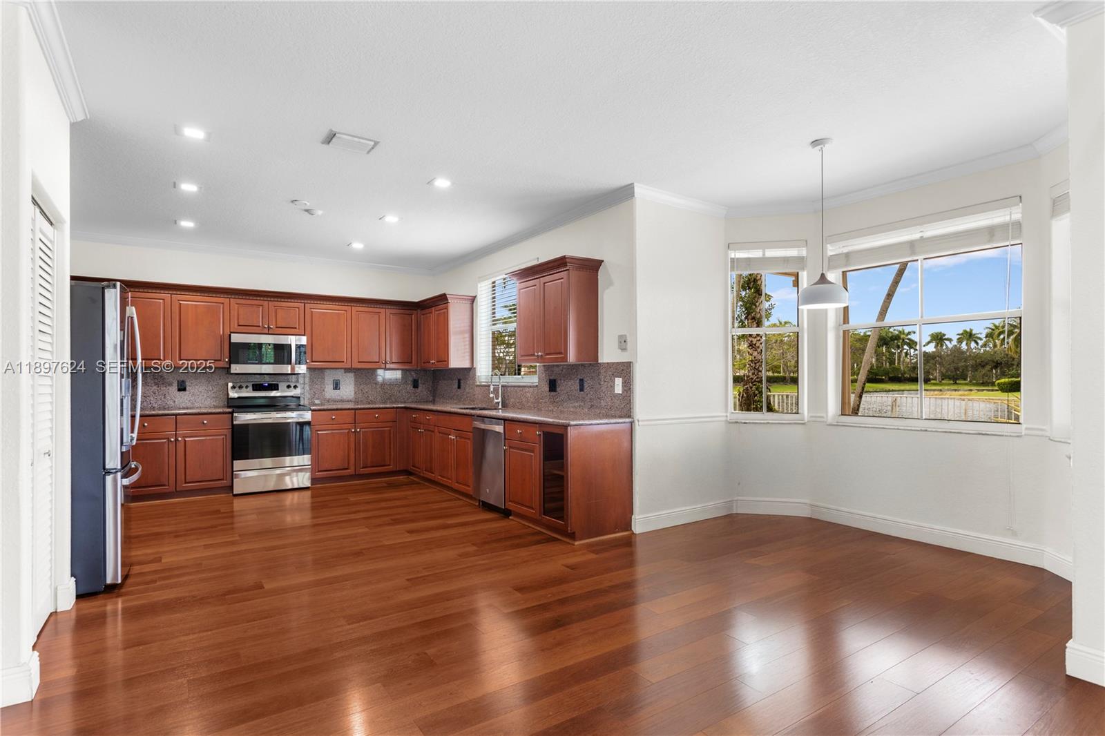 3620 Heron Ridge Lane Weston, FL 33331 - Photo 5 of 37 a kitchen with stainless steel appliances granite countertop a refrigerator and a stove top oven