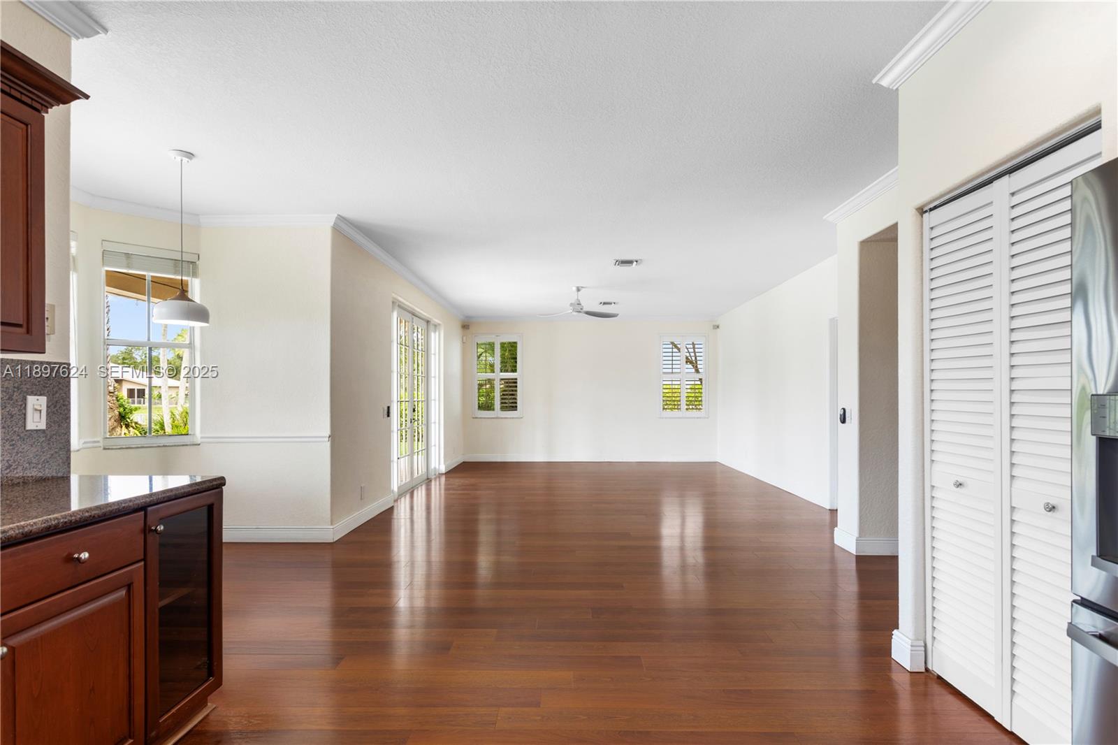 3620 Heron Ridge Lane Weston, FL 33331 - Photo 7 of 37 a view of an empty room with window and wooden floor