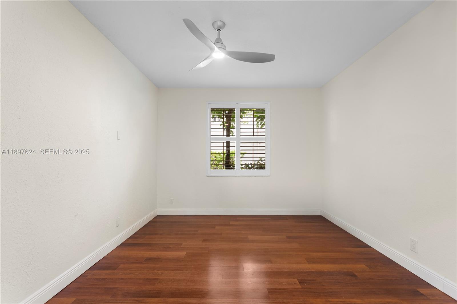 3620 Heron Ridge Lane Weston, FL 33331 - Photo 9 of 37 a view of an empty room with wooden floor and a window