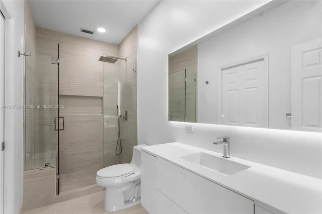 a bathroom with a sink toilet and shower