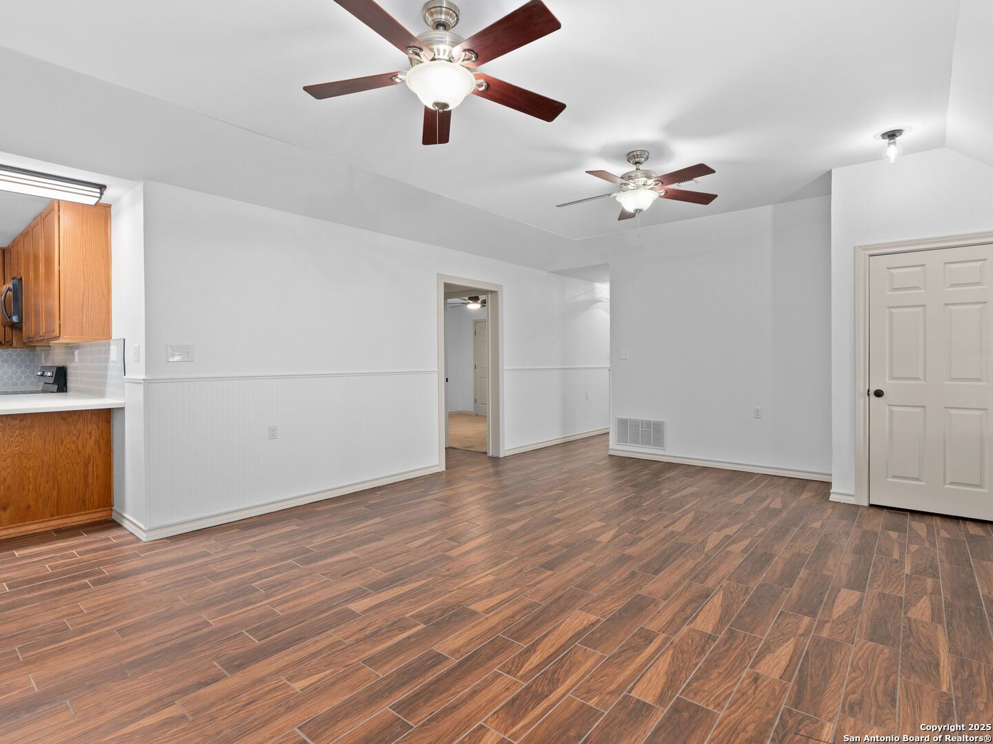 601 Wild Flower Drive Lytle, TX 78052 - Photo 15 of 50 a view of empty room with wooden floor and fan