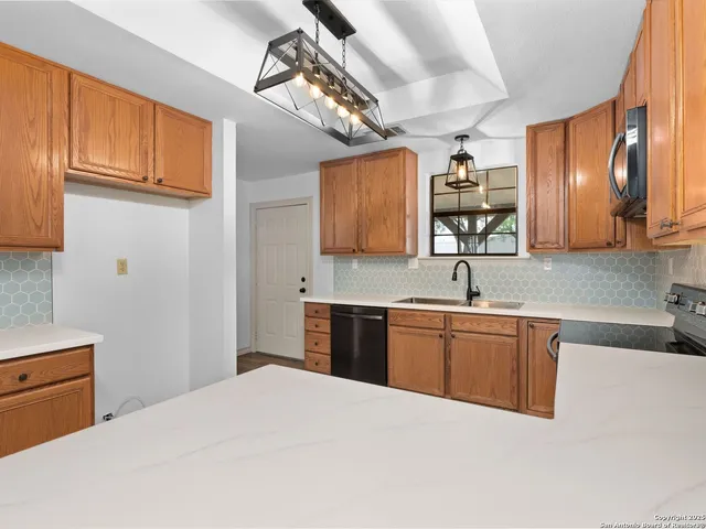 a kitchen with stainless steel appliances granite countertop a sink and cabinets