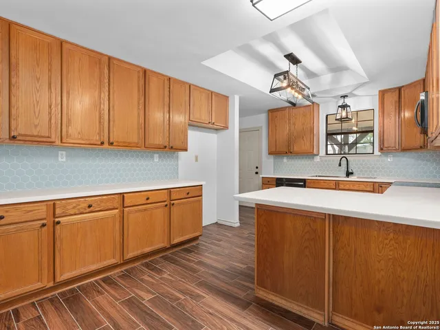 a kitchen with stainless steel appliances granite countertop wooden cabinets a sink and dishwasher