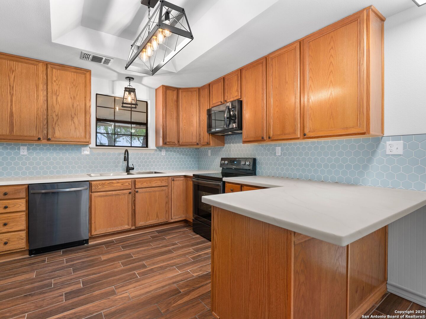 601 Wild Flower Drive Lytle, TX 78052 - Photo 19 of 50 a kitchen with a sink cabinets and window