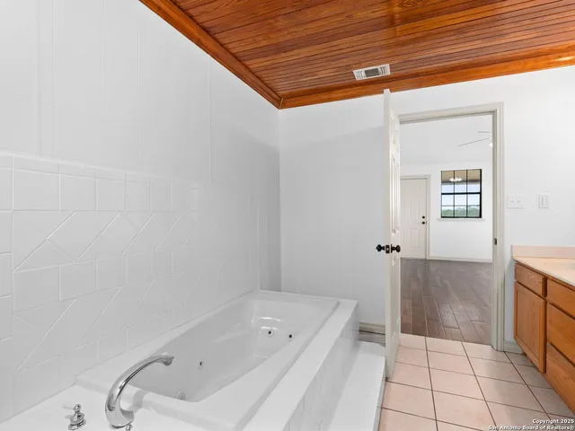 a bathroom with a tub and shower